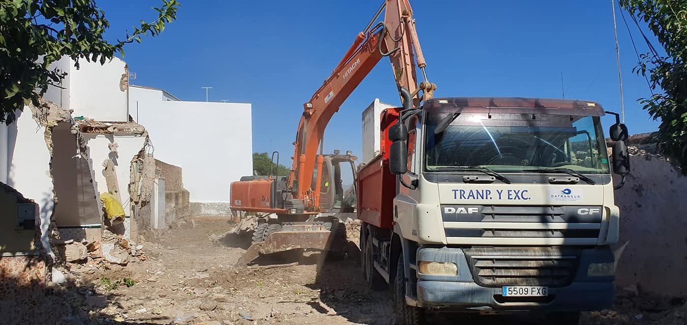 Camión y excavadora en demolición con retirada de escombro