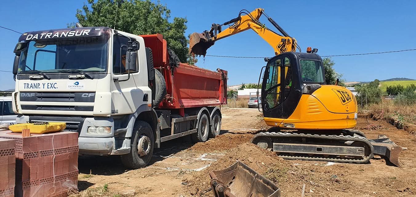 Excavadora cargando tierras en un camión de Datransur